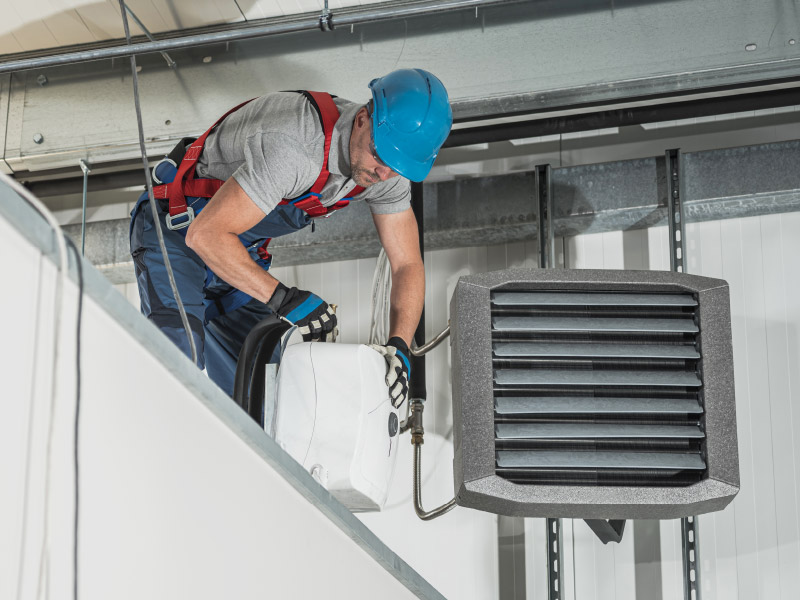 Technician Working on HVAC Fire Suppression System Technician Working on HVAC Fire Suppression System