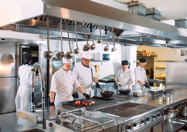 Chefs Cooking in a Commercial Kitchen Chefs Cooking in a Commercial Kitchen